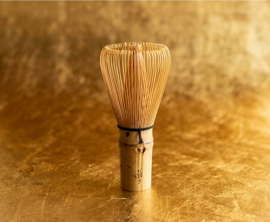 Bamboo whisk on a gold background
